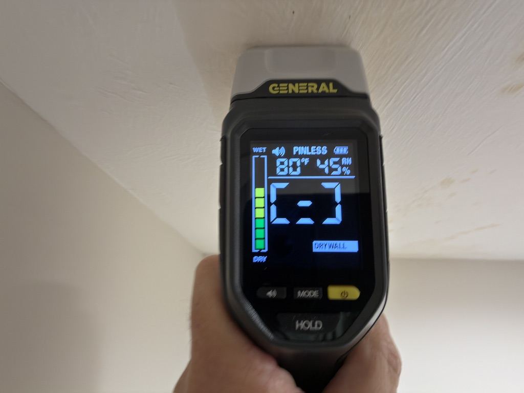 Moisture meter reading on a ceiling